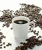 Cup of Coffee Surrounded by Coffee Beans