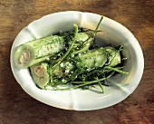 Two Stuffed Cucumbers in a Bowl; Dill