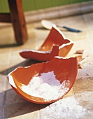 Flour Spilling From a Broken Bowl