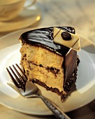 A Slice of Layered Yellow Cream Cake with Chocolate Frosting