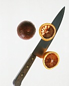 Two Blood Oranges; One Sliced Open; Knife