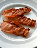 Three Strips of Bacon on a Plate