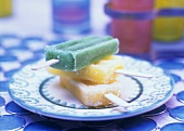 Three Citrus Popsicles in a Stack on a Plate