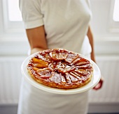 A Woman Holding a Tarte Tatin