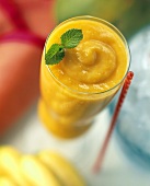 Mango Smoothie in a Tall Glass with Mint