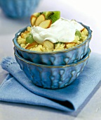 Couscous pudding with almonds, kiwi fruits and cream