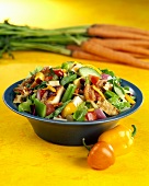 Colourful vegetable salad with bacon and chicken