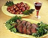 Sliced Herbed Roast Beef on Platter; Red Potatoes and Asparagus