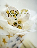 Rounds of white nougat with pistachios