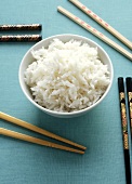 Bowl of rice, chopsticks beside it