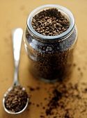 Instant coffee powder in a jar and on teaspoon