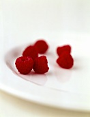 Raspberries on white plate