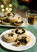 Several mince tartlets with a glass of wine