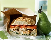 Brown Bag Lunch with Chicken Sandwich and a Pear