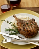 Grilled pork chop with mashed potato, rosemary, thyme