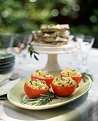 Roasted Tomatoes Filled with Herbed Eggs on an Outdoor Table