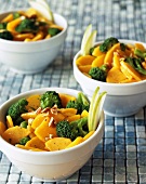 Steamed Carrots and Broccoli with Walnuts in White Bowls
