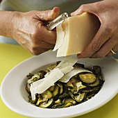 Shaving Parmesan onto Cooked and Sliced Zucchini