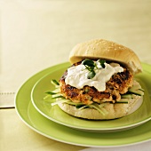 A Salmon Burger with Mayo, Green Onion and Cucumbers