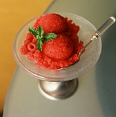 Raspberry ice cream with mint and fresh raspberries