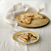Two Slices of Apple Pizza on a Plate with Whole in Background
