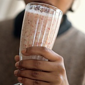 A Person Holding A Strawberry Shake