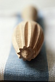 Wooden lemon squeezer on blue and white cloth