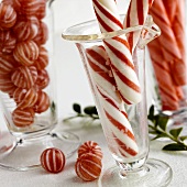 Candy canes and peppermint sweets in glass vases