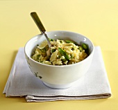 Risotto with peas and Parmesan in small white bowl