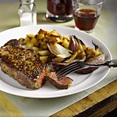 Beef steak with fried potatoes and onions