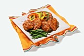 Barbecued Chicken on a Square Platter with Green Beans and Bell Peppers