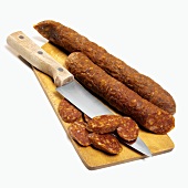 Paprika sausage with slices cut on chopping board