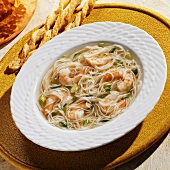 A Bowl of Angel Hair and Shrimp Soup with Cheese Bread Sticks