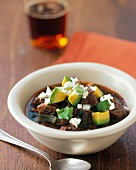 A Bowl of Hearty Beef Chili with Avocadoes
