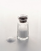 A Salt Shaker on White with Spilled Salt