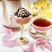 Chocolate Fudge Mousse in a Stem Glass with a Cup of Tea