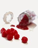 Fresh Raspberries with Raspberry Jam Spilling from a Glass Jar