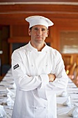 Chef in front of a laid table in a restaurant