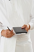 A Waiter Holding a Leather Bi-fold and Pen