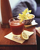 A Bloody Mary on a Side Table with Squeezed Lemon Half