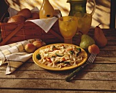 Farfalle with vegetables on a yellow plate