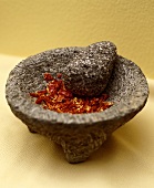 A Pestle and Mortar with Dried Chilis