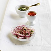 Slices of Red Onion, Pepper Coulis and Pesto