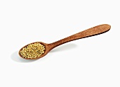 Wooden Spoonful of Mustard Seeds on White Background