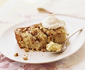 A piece of apple cake with cream