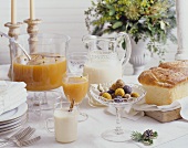 Breakfast buffet with brioche, milk and orange punch