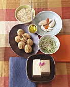 Still life with tofu, walnuts, sprouts, garlic and cereals