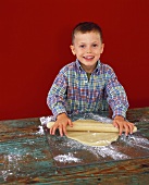 Boy rolling out pastry