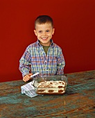 Boy marbling cheesecake brownies with butter knife