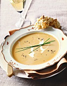 Bowl of Pureed Squash Soup with Crème Fraiche Swirl and Scallion Garnish; Bread